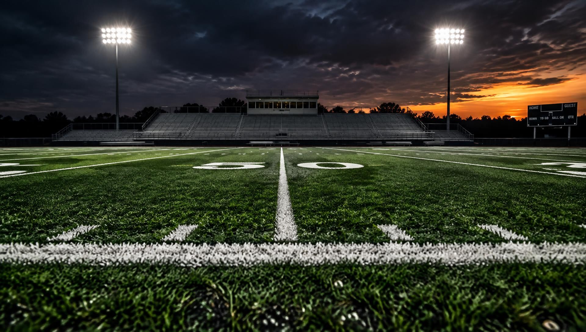 Artificial turf football field under stadium lights